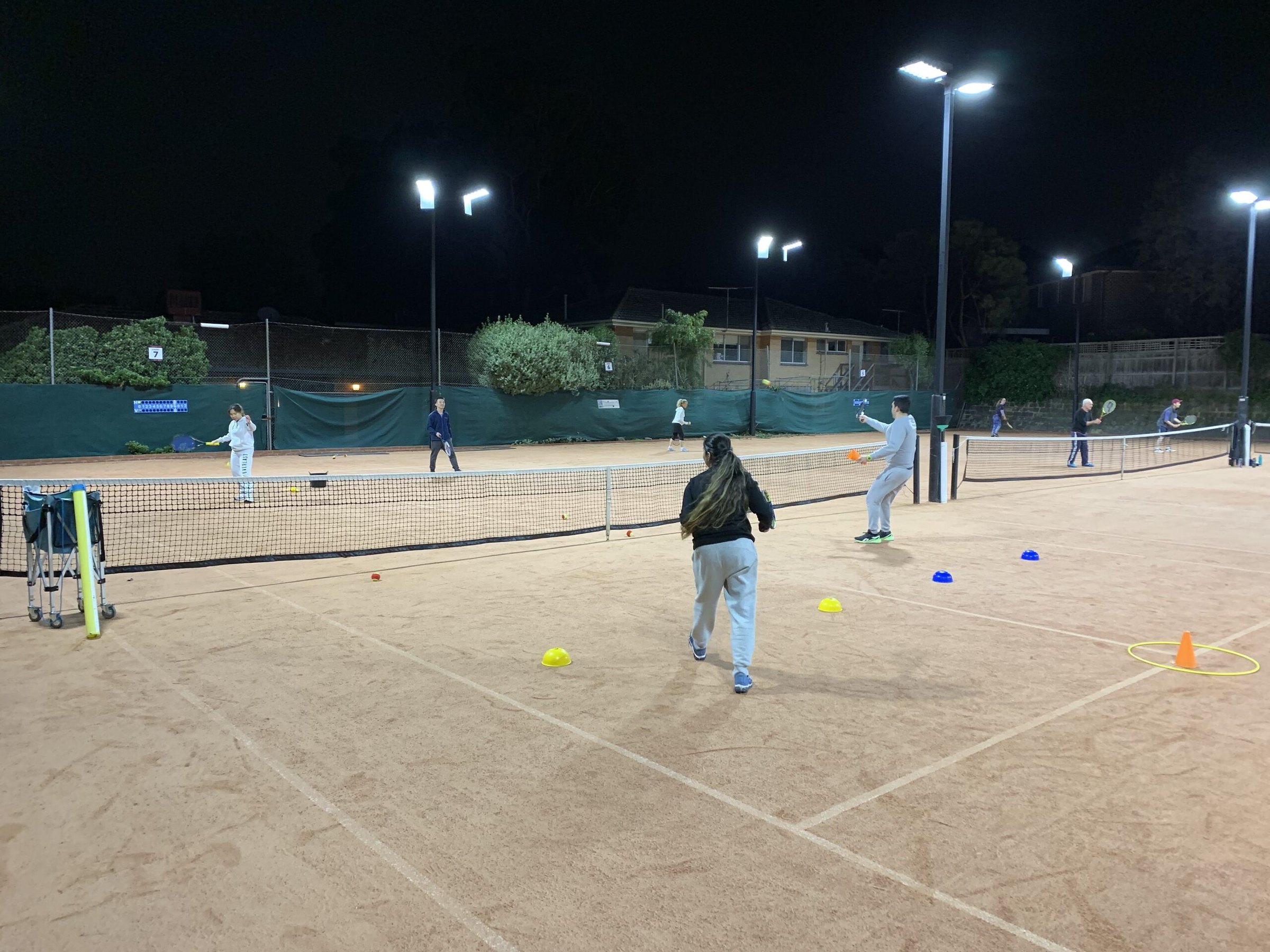 Adult group coaching under lights