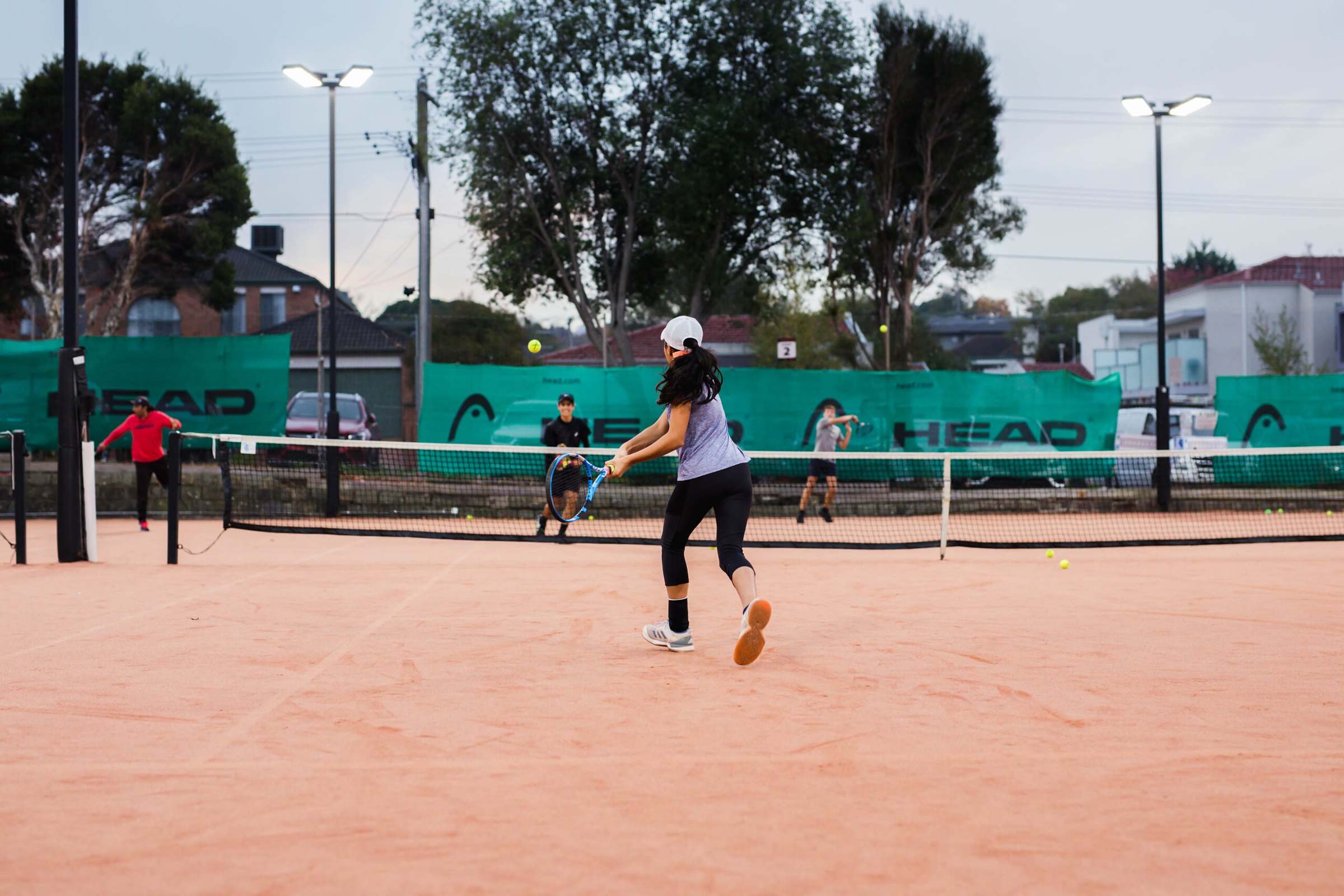 A junior player rallying on the clay at Box Hill