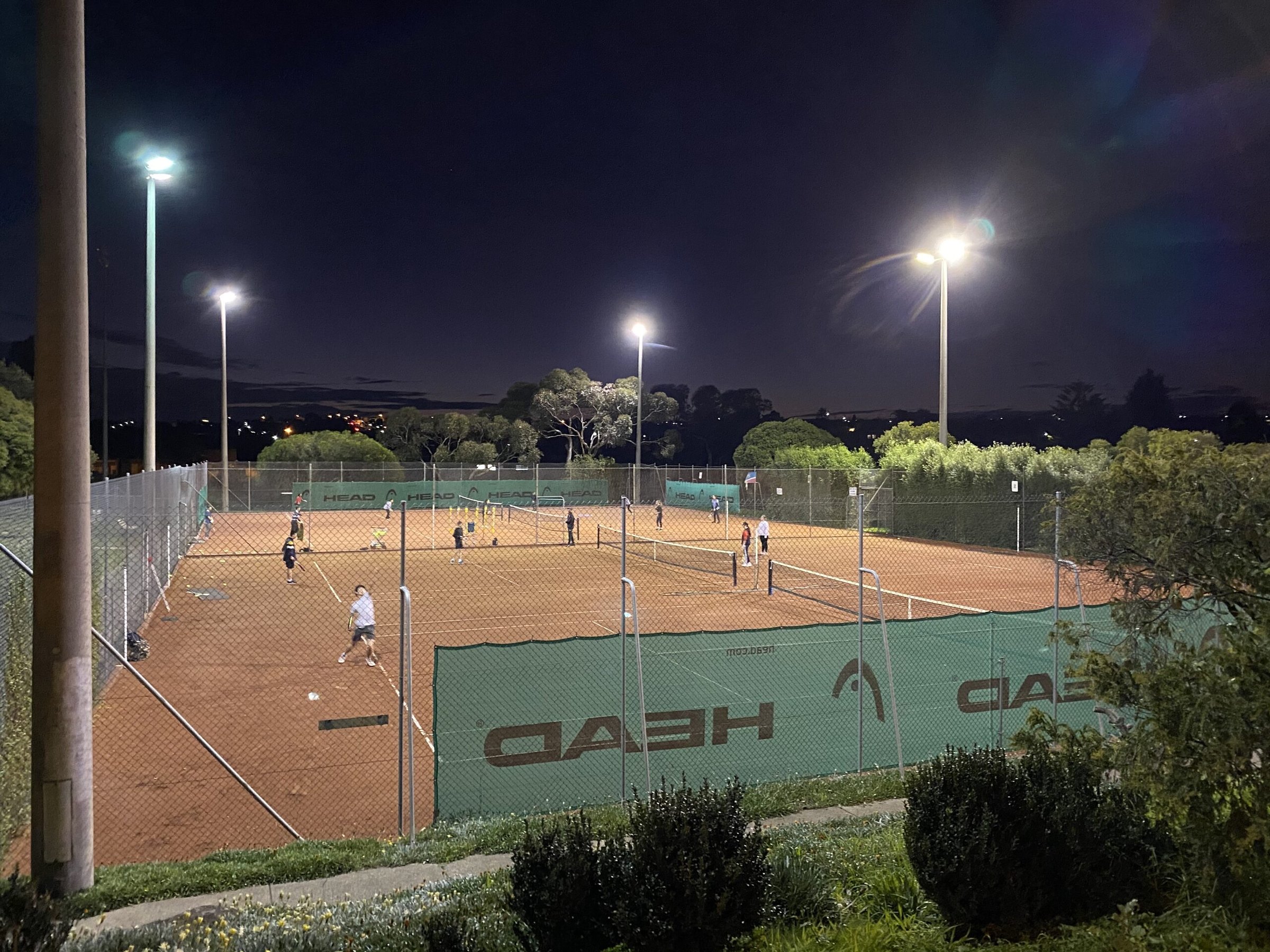 The clay courts lit up at night from above
