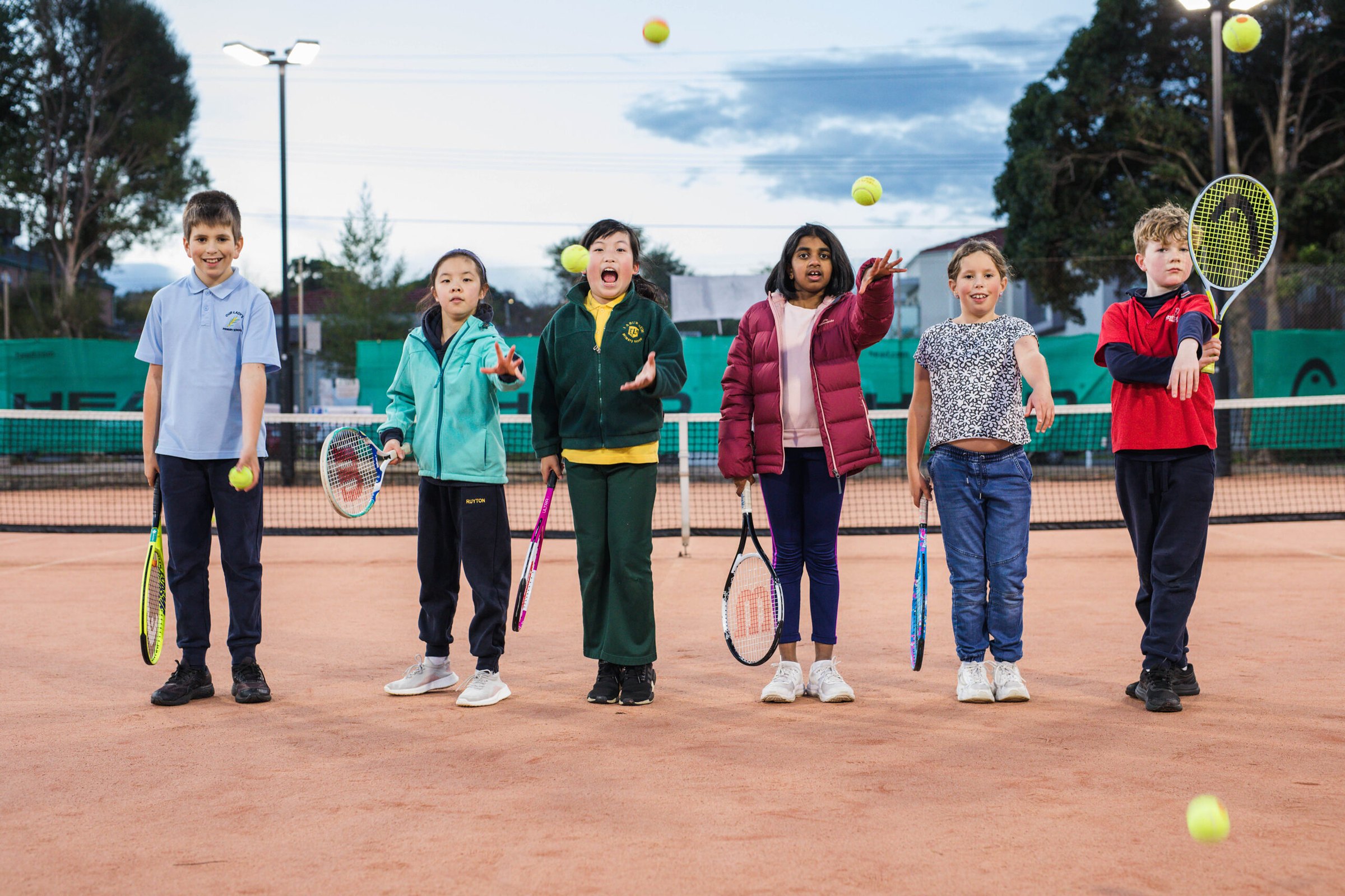 Hot Shots kids lined up as coaches throw balls in the air